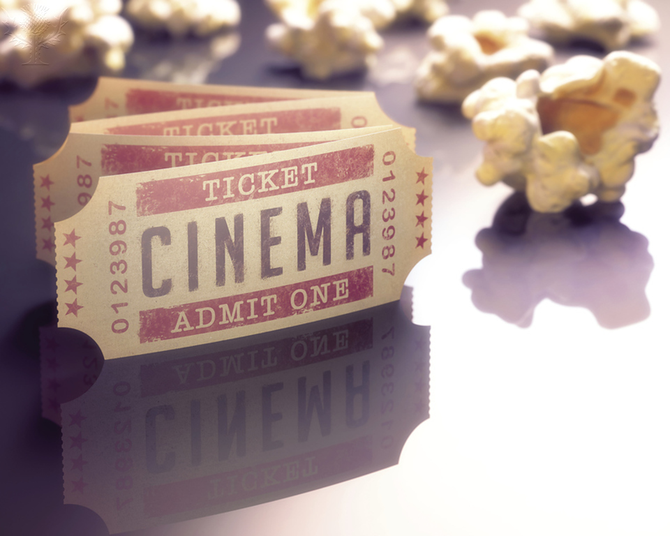 Stock photo of cinema ticket and loose popcorn