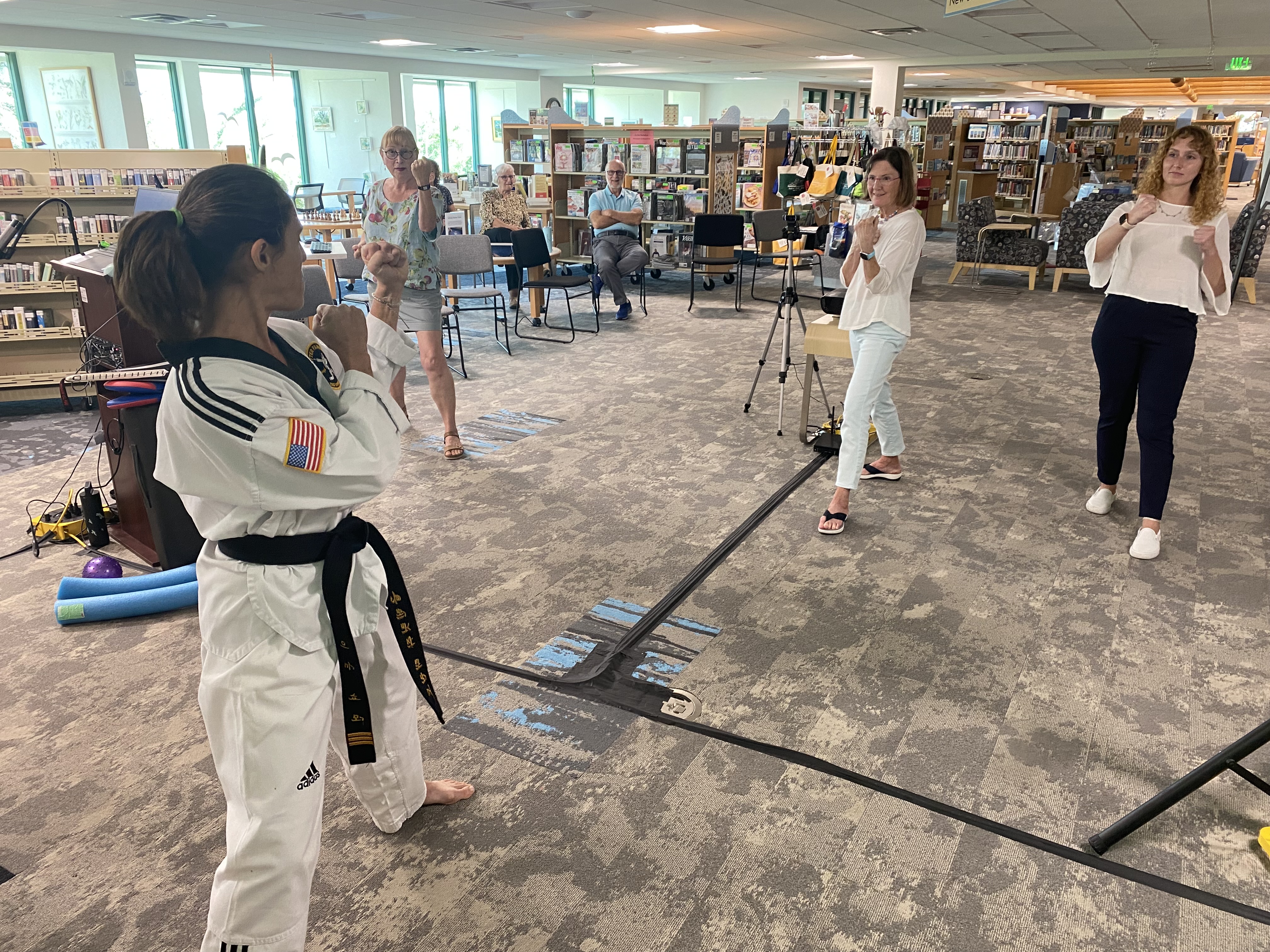 Eden teaching a martial arts class to a group of women in the Sanibel Public Library.