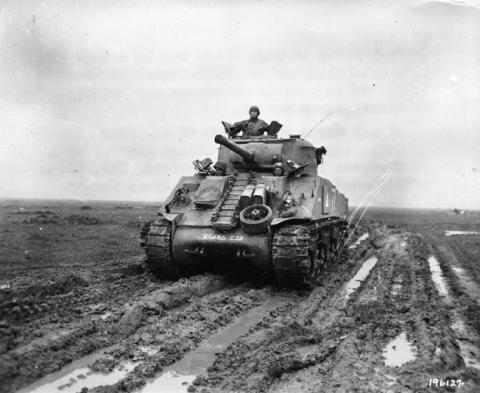 An M4 Sherman tank driving in the mud