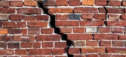 A Broken Brick Wall indicating overcoming barriers