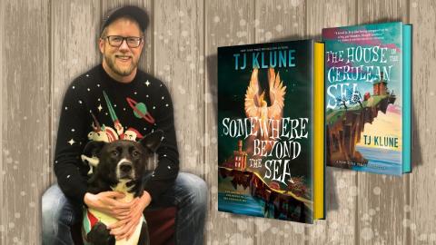 Author TJ Klune, his dog, and his two books "Somewherer Beyond the Sea" and "The House in the Cerulean Sea"