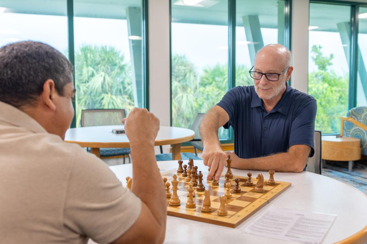 Patrons playing chess in the Library.