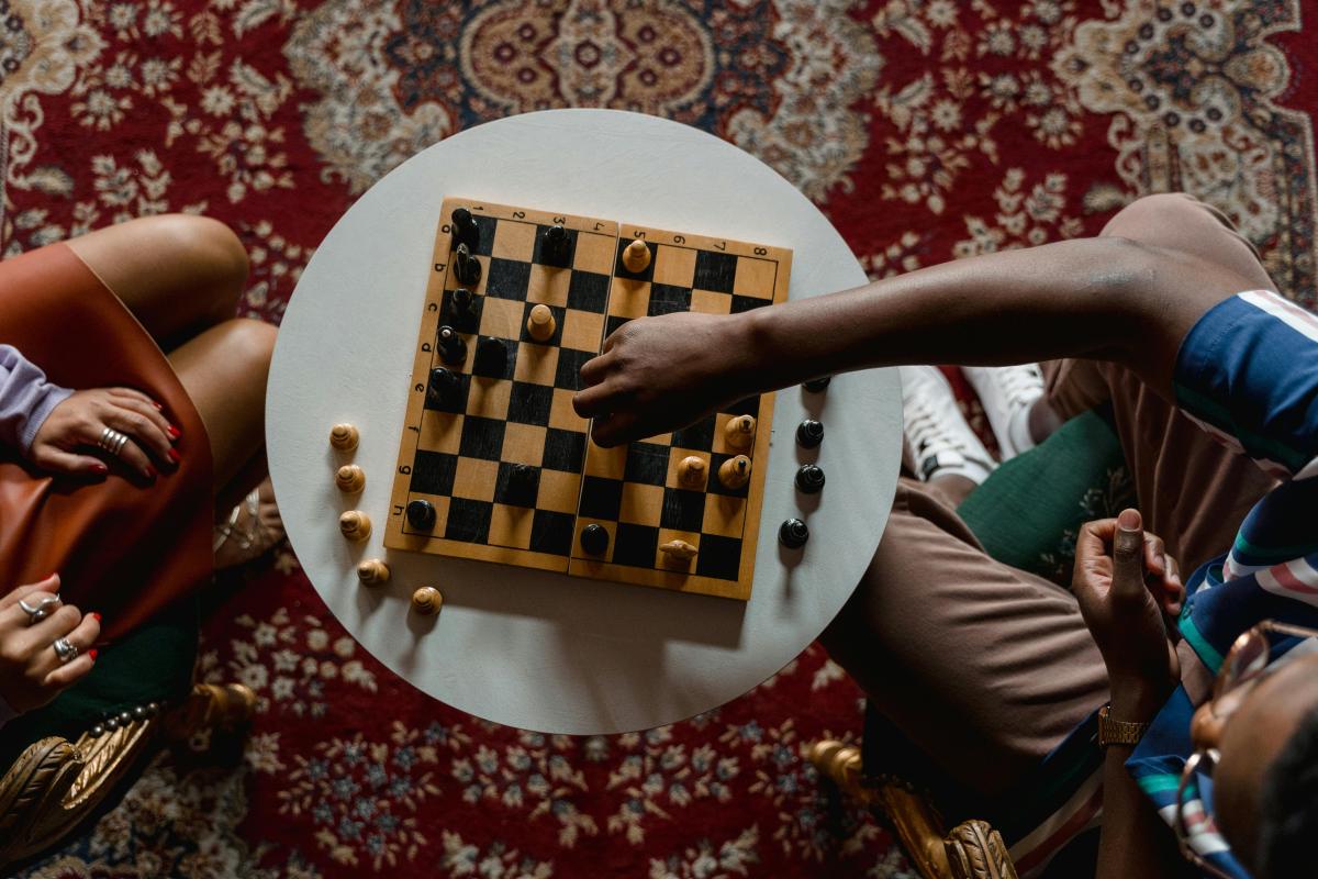 Overhead view of two people playing chess