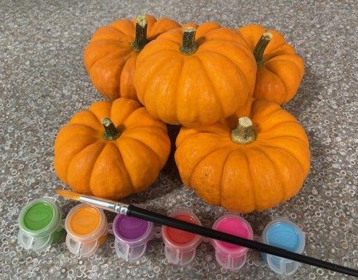 mini pumpkins with paintbrush and paints